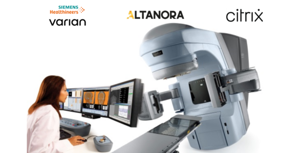 Female clinician operating a machine that takes mammograms
